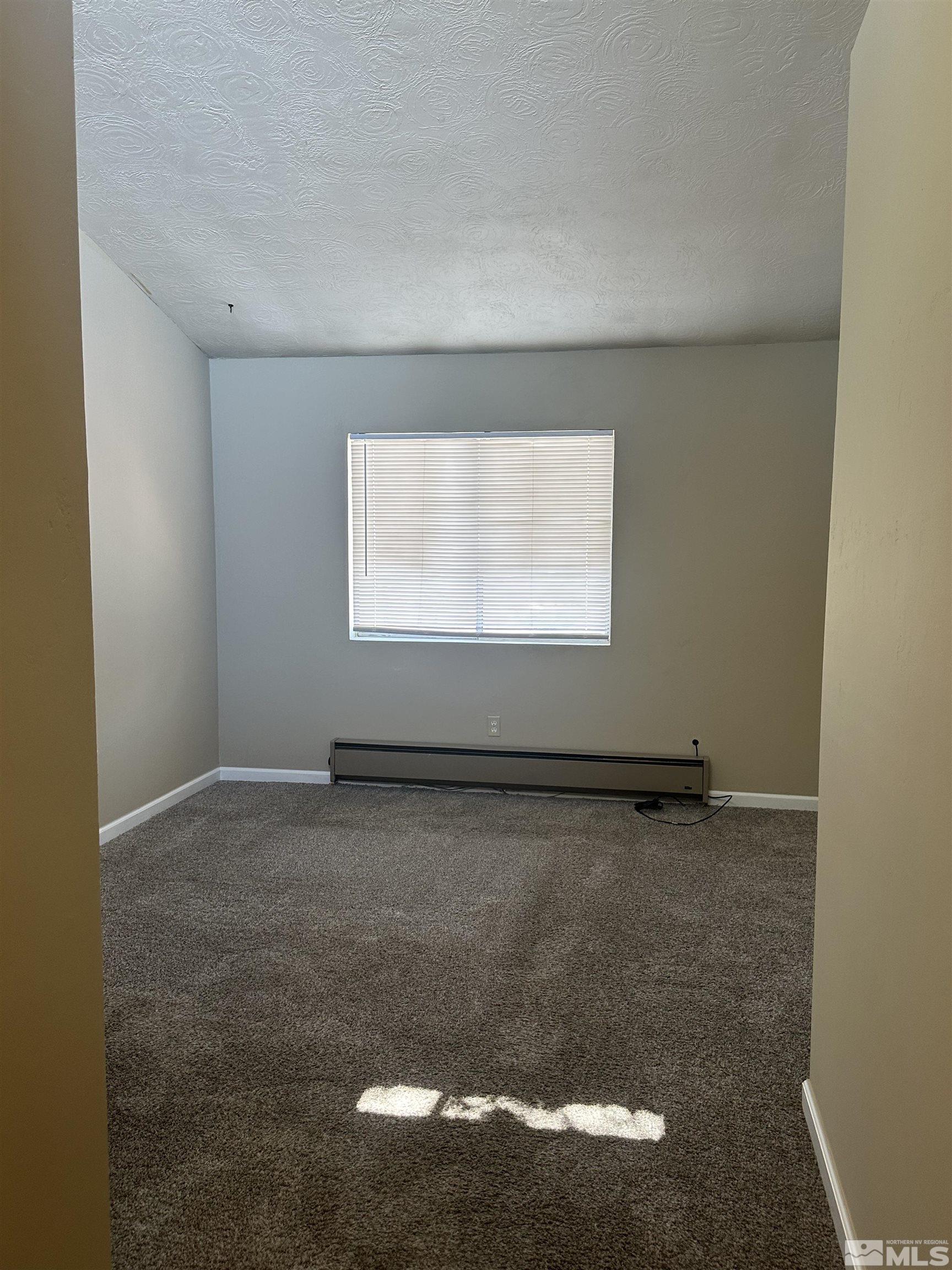 2101 Highview Court, Unit 18 Reno, NV 89512 - Photo 2 of 12 a view of an empty room with a window