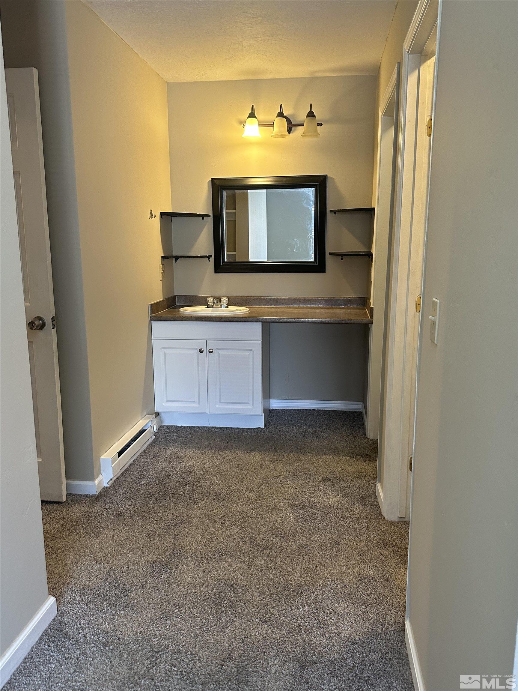 2101 Highview Court, Unit 18 Reno, NV 89512 - Photo 3 of 12 a bathroom with a sink and a mirror