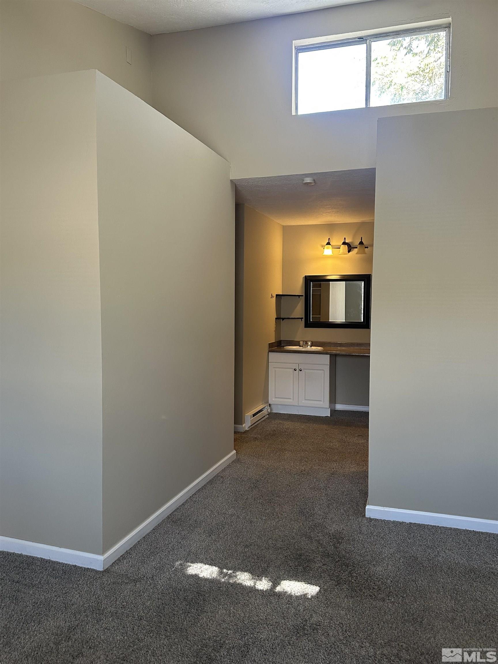 2101 Highview Court, Unit 18 Reno, NV 89512 - Photo 6 of 12 an empty room with a fireplace and wooden floor