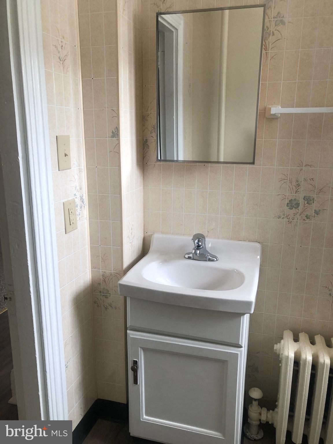 70 North Main Street, Unit 3 Spring City, PA 19475 - Photo 11 of 11 a bathroom with a sink and a mirror