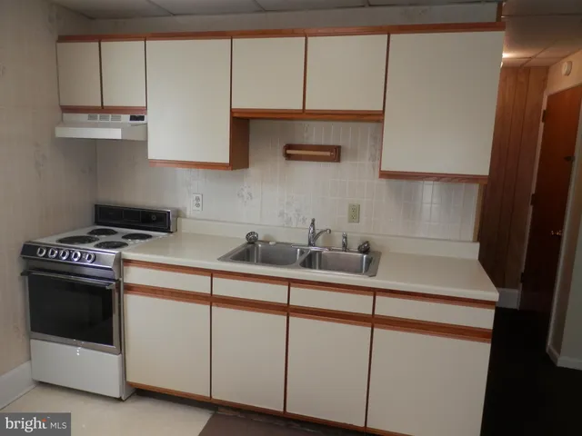 a view of a small space with wooden floor and a window