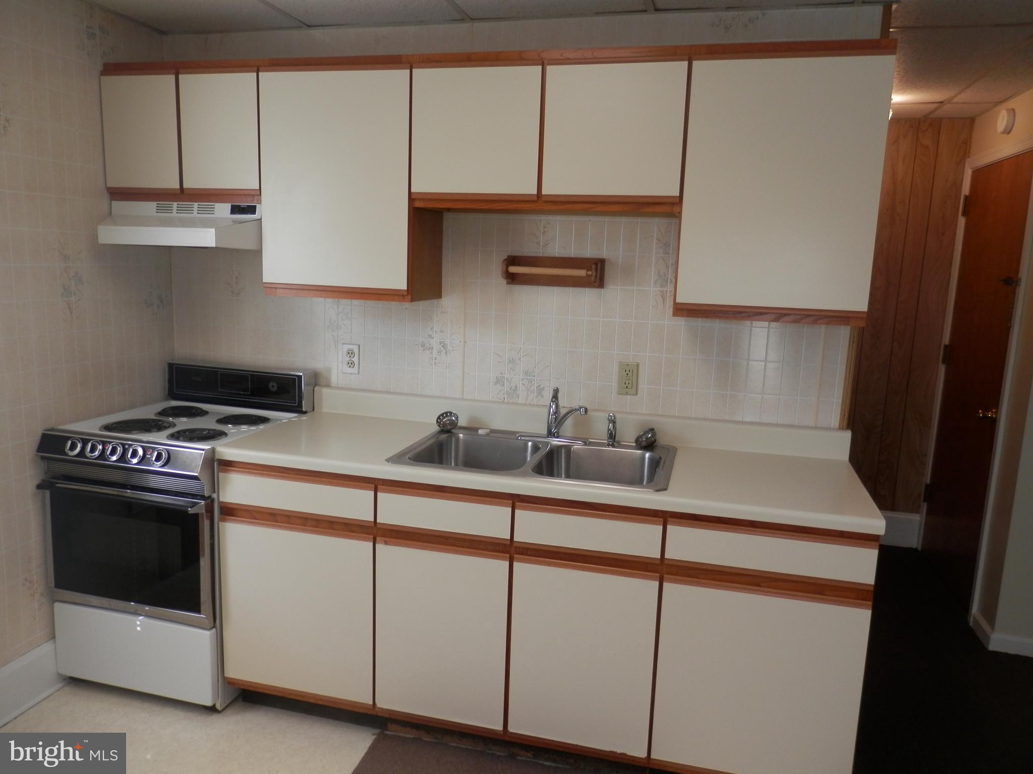 70 North Main Street, Unit 3 Spring City, PA 19475 - Photo 5 of 11 a kitchen with white cabinets and white appliances