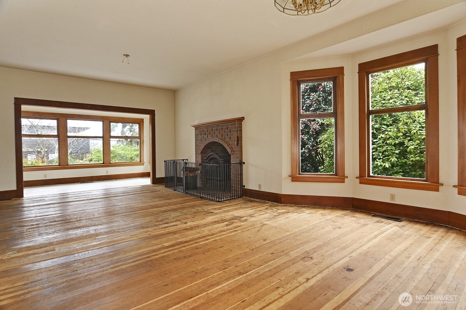 3244 Northwest 64th Street Seattle, WA 98107 - Photo 11 of 32 a view of empty room with floor to ceiling window and wooden floor