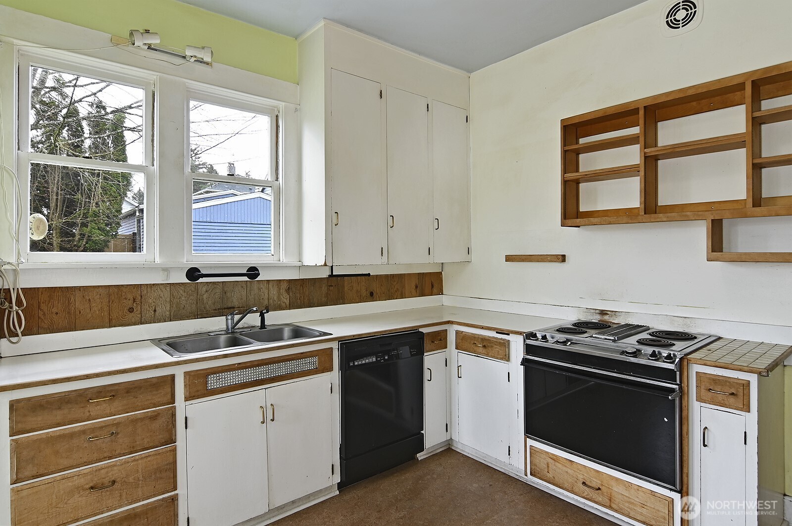 3244 Northwest 64th Street Seattle, WA 98107 - Photo 16 of 32 a kitchen that has a sink and a stove