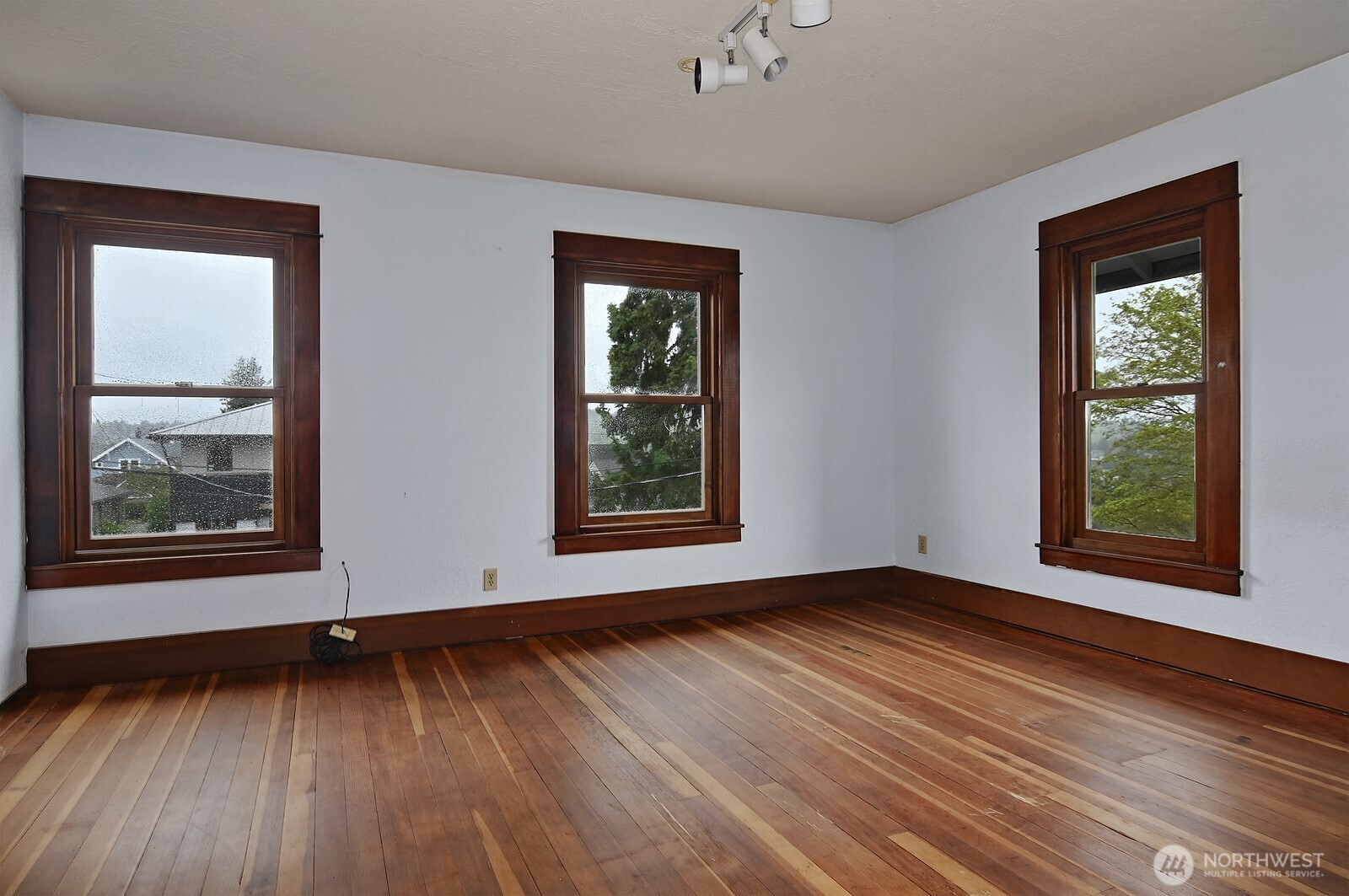 3244 Northwest 64th Street Seattle, WA 98107 - Photo 21 of 32 an empty room with wooden floor and windows