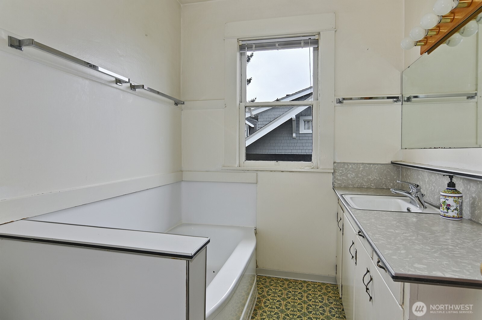 3244 Northwest 64th Street Seattle, WA 98107 - Photo 28 of 32 a bathroom with a granite countertop sink a toilet and a mirror