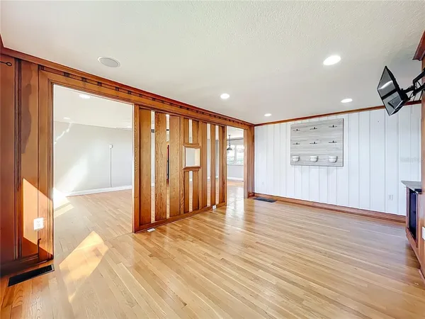 a view of a livingroom with wooden floor and a cabinet