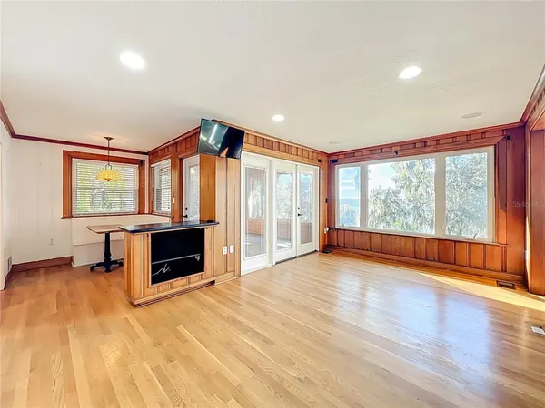 a view of empty room with wooden floor
