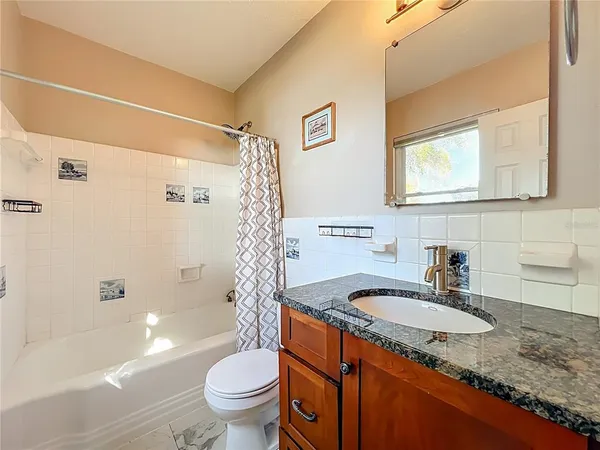 an aerial view of a house with swimming pool and garden