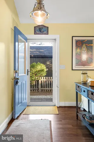 a kitchen with a sink and chairs