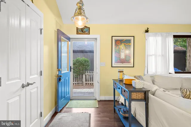 a kitchen with stainless steel appliances granite countertop a sink a stove a refrigerator with a dining table and chairs