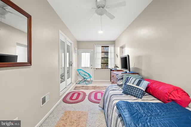 a bedroom with a bed a couch and a window