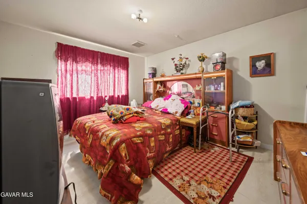 a bed sitting in a bedroom next to a window