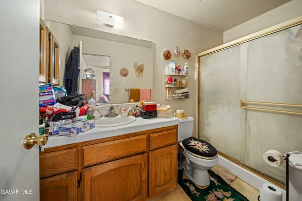a bathroom with a sink mirror toilet and shower