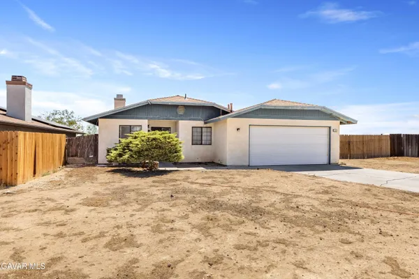 a view of a house with a yard and garage