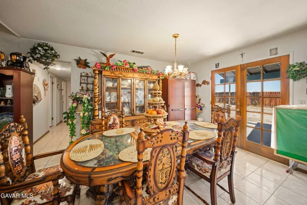 a view of a dining room with furniture and chandelier