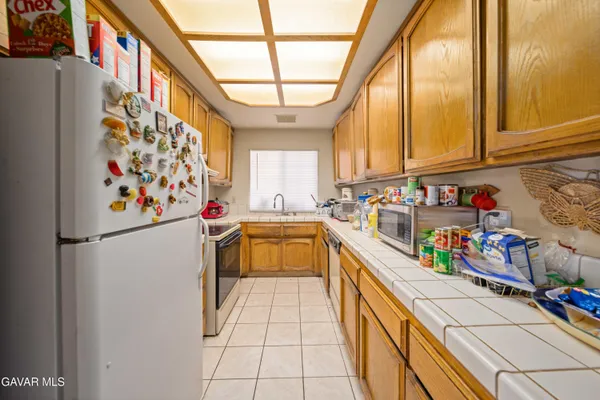 a kitchen with stainless steel appliances a refrigerator and a sink