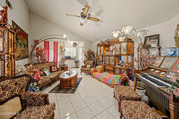a very nice looking living room with furniture and a chandelier