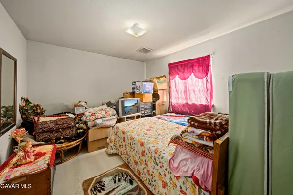 a bedroom with furniture and a closet