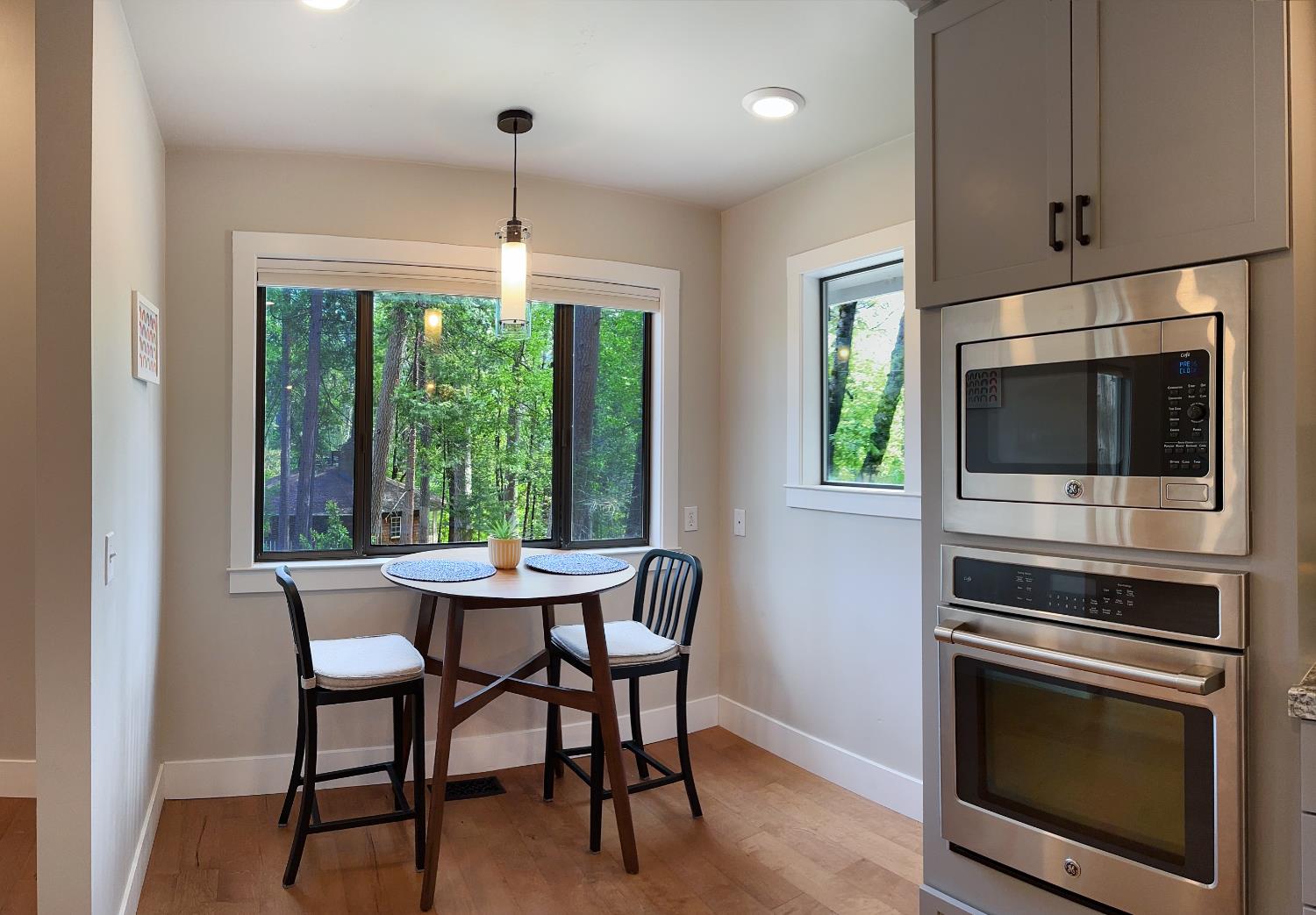 157 Grove Street Nevada City, CA 95959 - Photo 12 of 55 a dining room with furniture a fireplace a rug and a chandelier