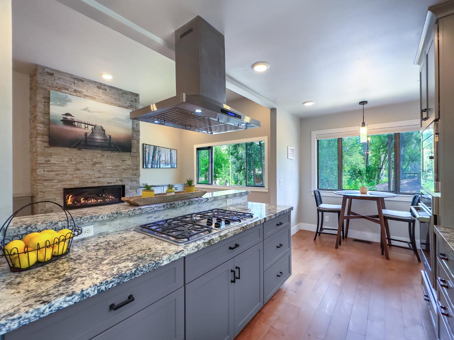 157 Grove Street Nevada City, CA 95959 - Photo 17 of 55 a kitchen with stainless steel appliances granite countertop a stove and a wooden floors