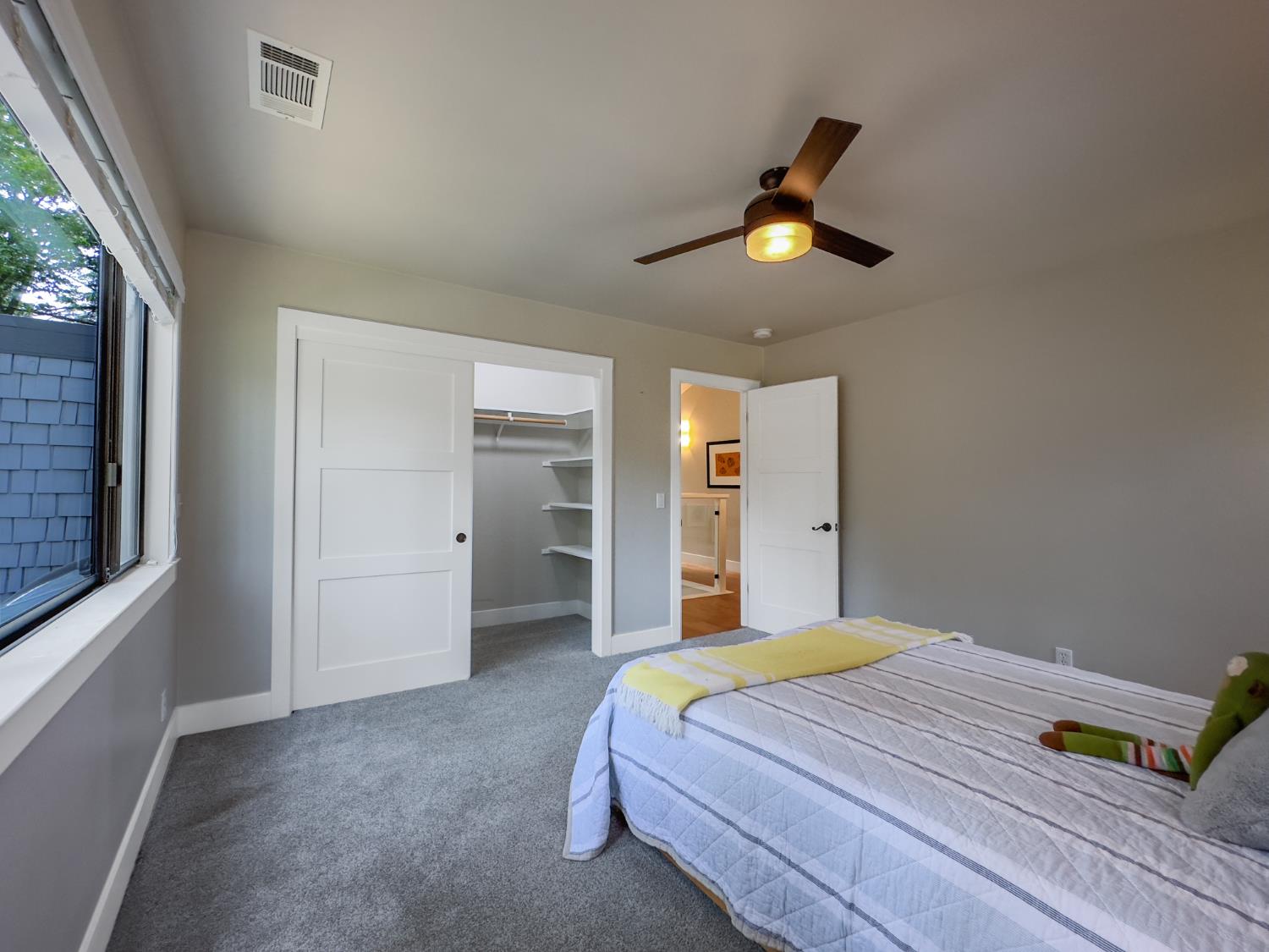 157 Grove Street Nevada City, CA 95959 - Photo 20 of 55 a bedroom with a bed and a chandelier