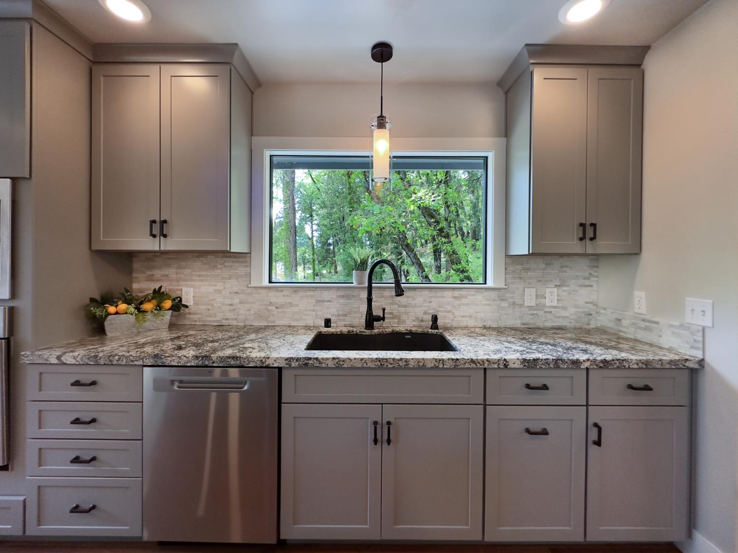 157 Grove Street Nevada City, CA 95959 - Photo 23 of 55 a kitchen with granite countertop white cabinets and window