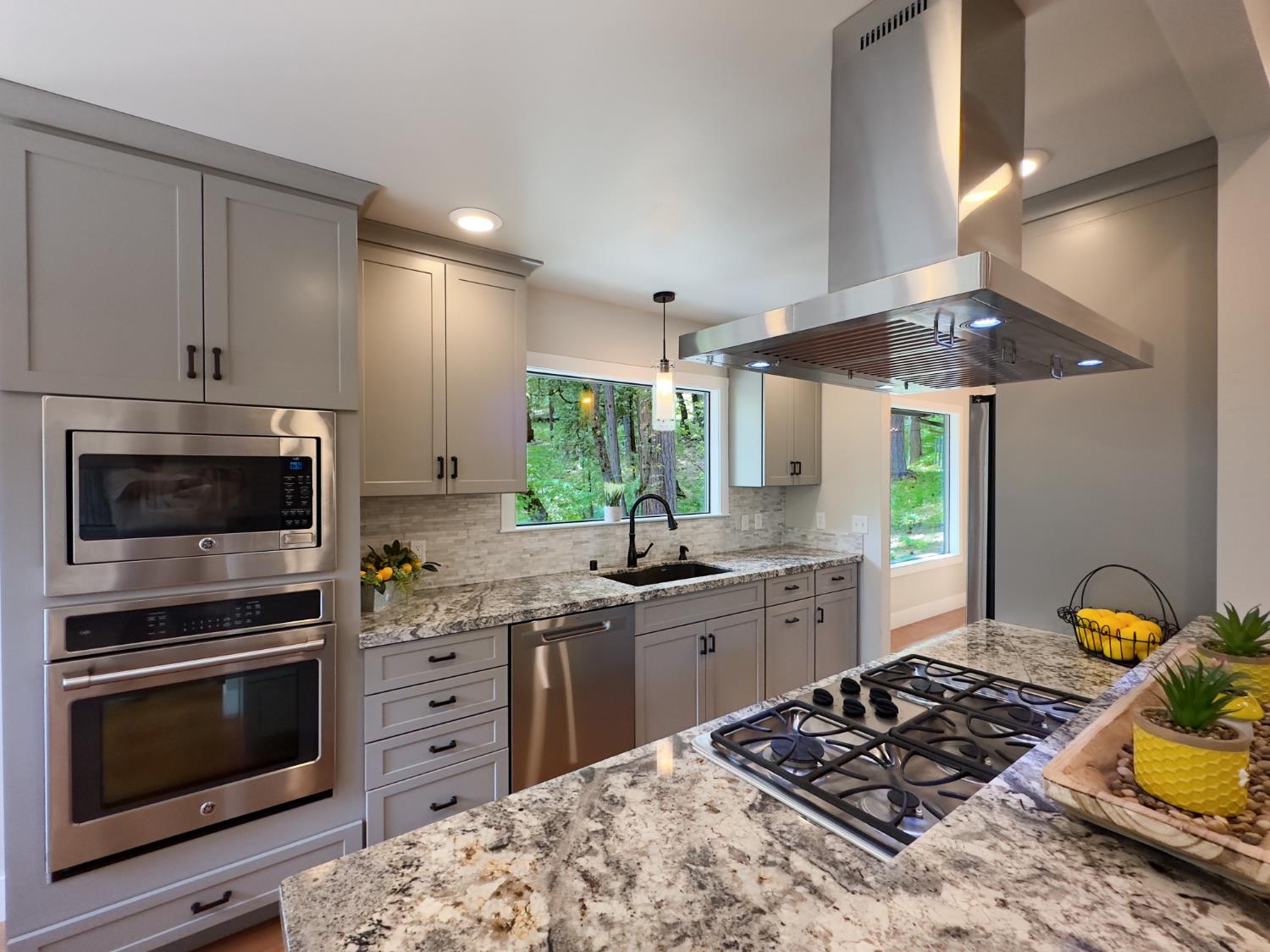157 Grove Street Nevada City, CA 95959 - Photo 24 of 55 a kitchen with stainless steel appliances a stove a sink and a microwave