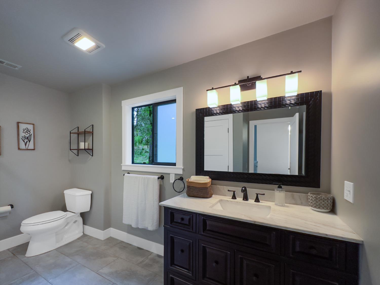 157 Grove Street Nevada City, CA 95959 - Photo 45 of 55 a bathroom with a toilet sink double vanity and mirror