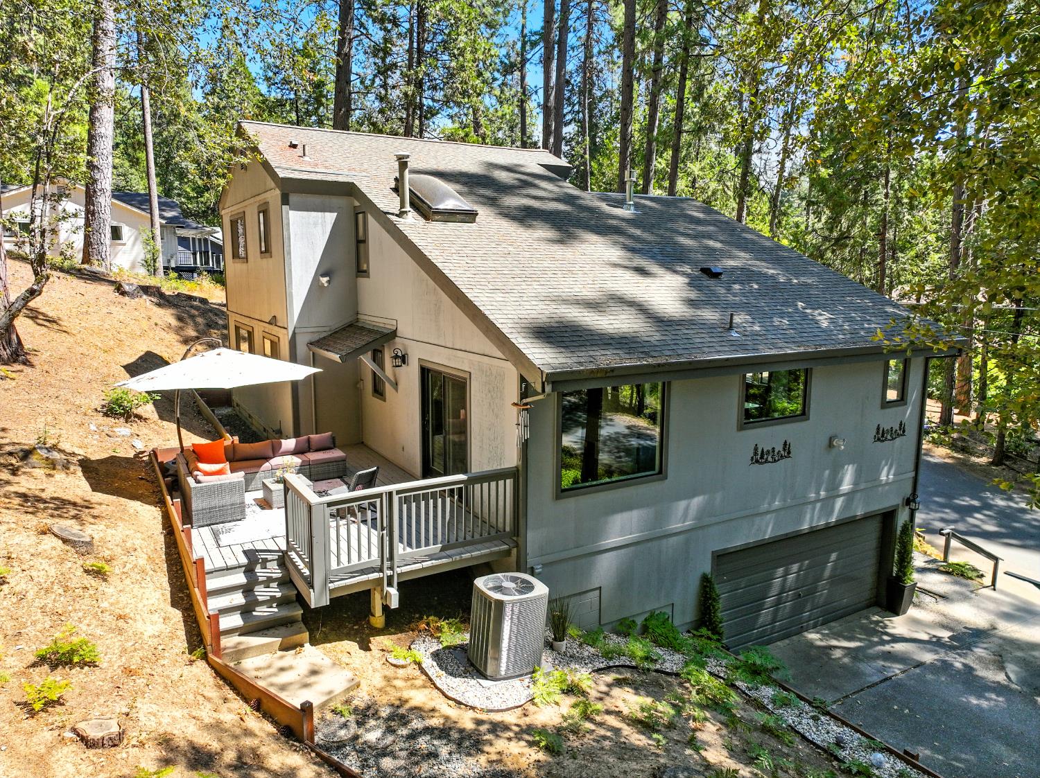 157 Grove Street Nevada City, CA 95959 - Photo 54 of 55 a view of a patio with table and chairs potted plants and large tree