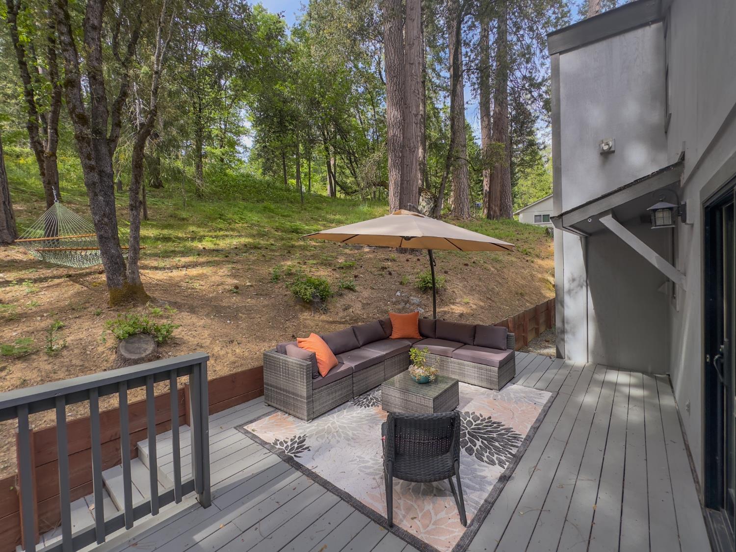 157 Grove Street Nevada City, CA 95959 - Photo 9 of 55 a view of a roof deck with table and chairs under an umbrella with wooden floor