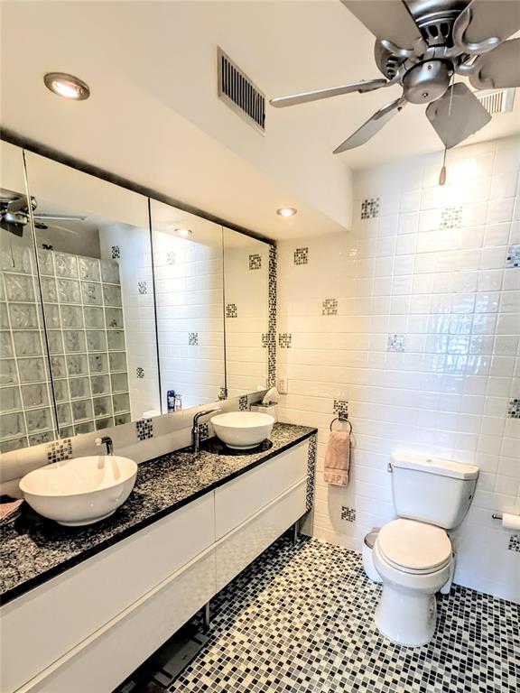 1546 Stickney Point Road, Unit 501 Sarasota, FL 34231 - Photo 17 of 34 a bathroom with a granite countertop sink toilet a mirror and shower