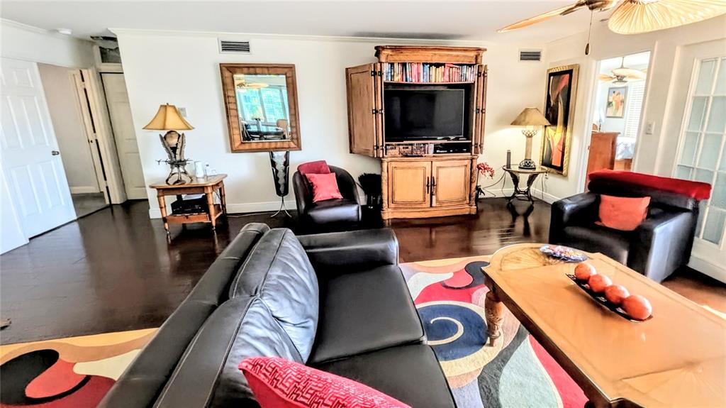 1546 Stickney Point Road, Unit 501 Sarasota, FL 34231 - Photo 7 of 34 a living room with furniture and a flat screen tv