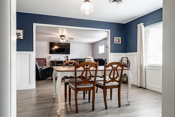 a view of a dining room with furniture and wooden floor