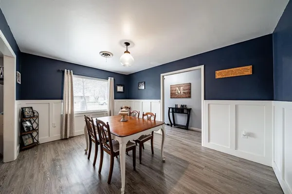a view of a dining room with furniture and wooden floor
