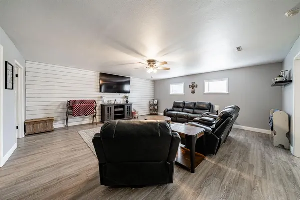 a living room with furniture a fireplace and a flat screen tv