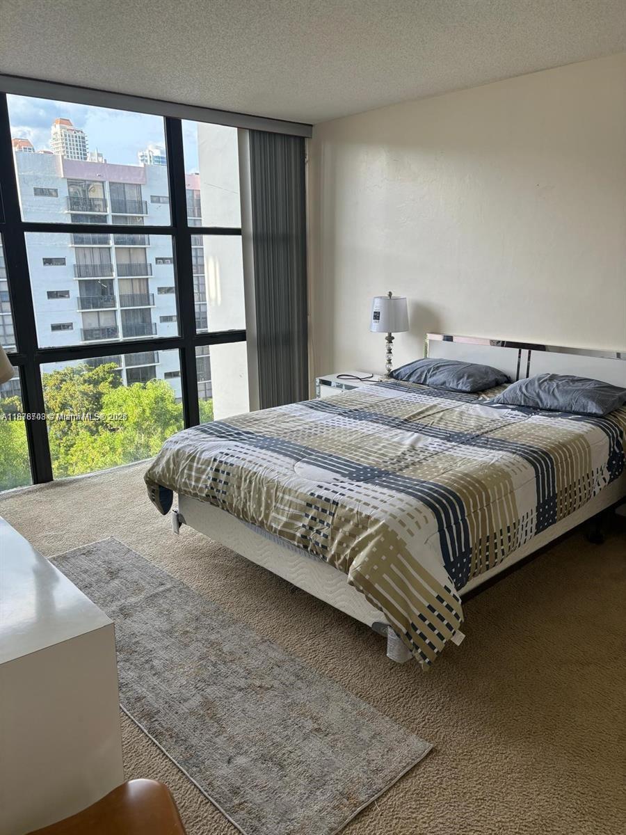 17011 North Bay Road, Unit 805 Sunny Isles Beach, FL 33160 - Photo 14 of 25 a bedroom with a bed and a large window