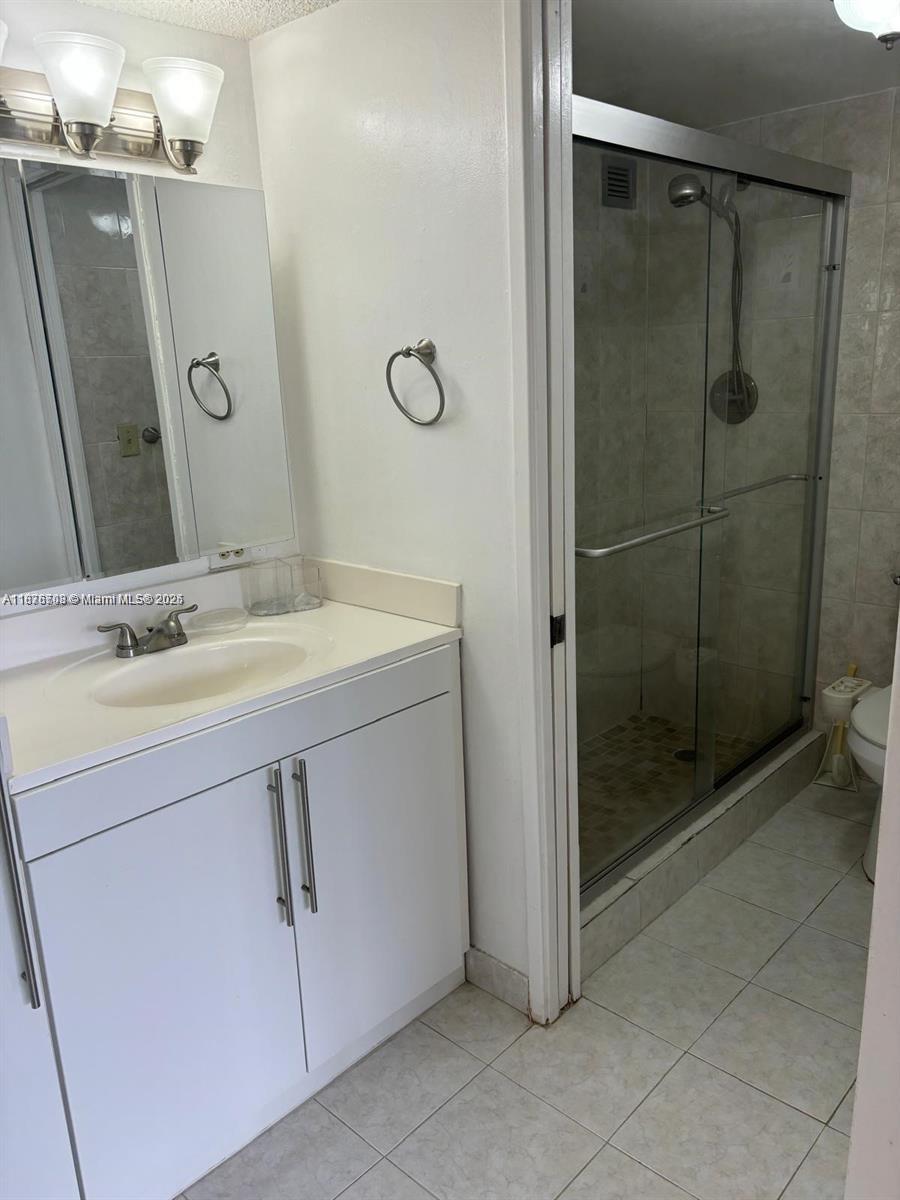 17011 North Bay Road, Unit 805 Sunny Isles Beach, FL 33160 - Photo 15 of 25 a bathroom with a shower sink and mirror