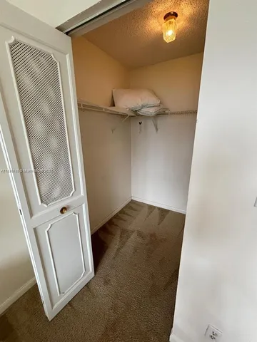 a view of a livingroom with furniture and a window