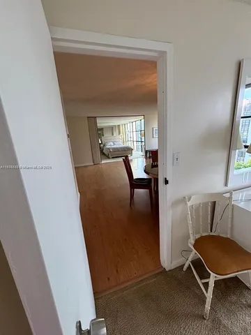 a view of a living room with furniture and a potted plant