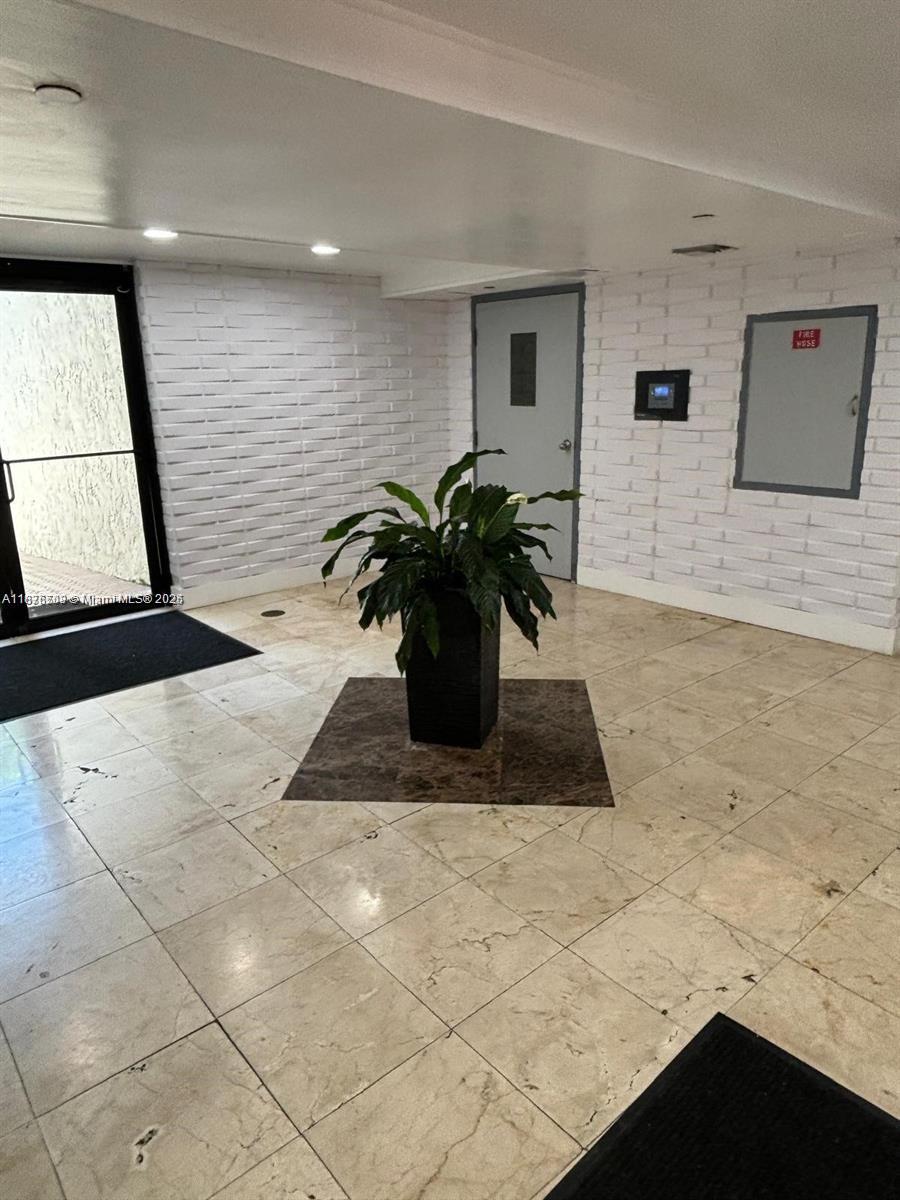 17011 North Bay Road, Unit 805 Sunny Isles Beach, FL 33160 - Photo 21 of 25 a view of a living room with furniture and a potted plant