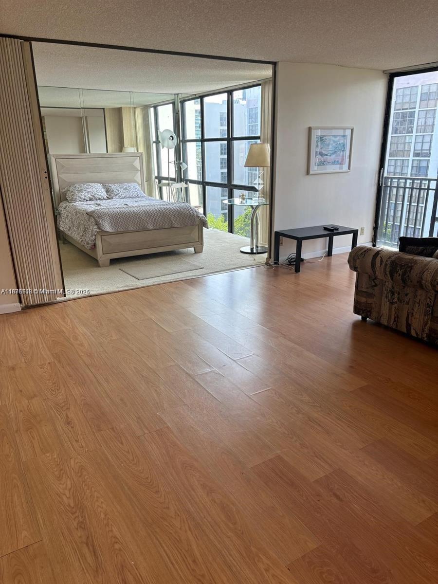 17011 North Bay Road, Unit 805 Sunny Isles Beach, FL 33160 - Photo 6 of 25 a bedroom with a bed and a couch next to a window