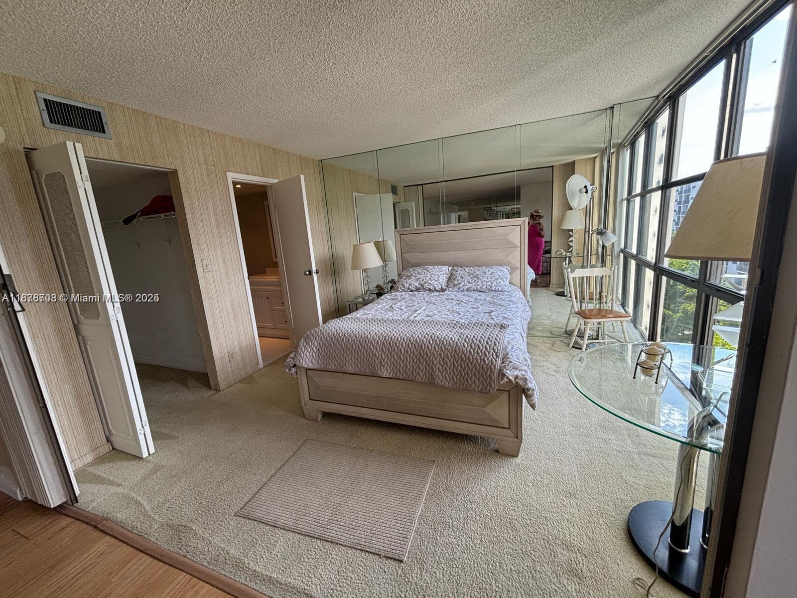 17011 North Bay Road, Unit 805 Sunny Isles Beach, FL 33160 - Photo 7 of 25 a bedroom with a large bed and a large window