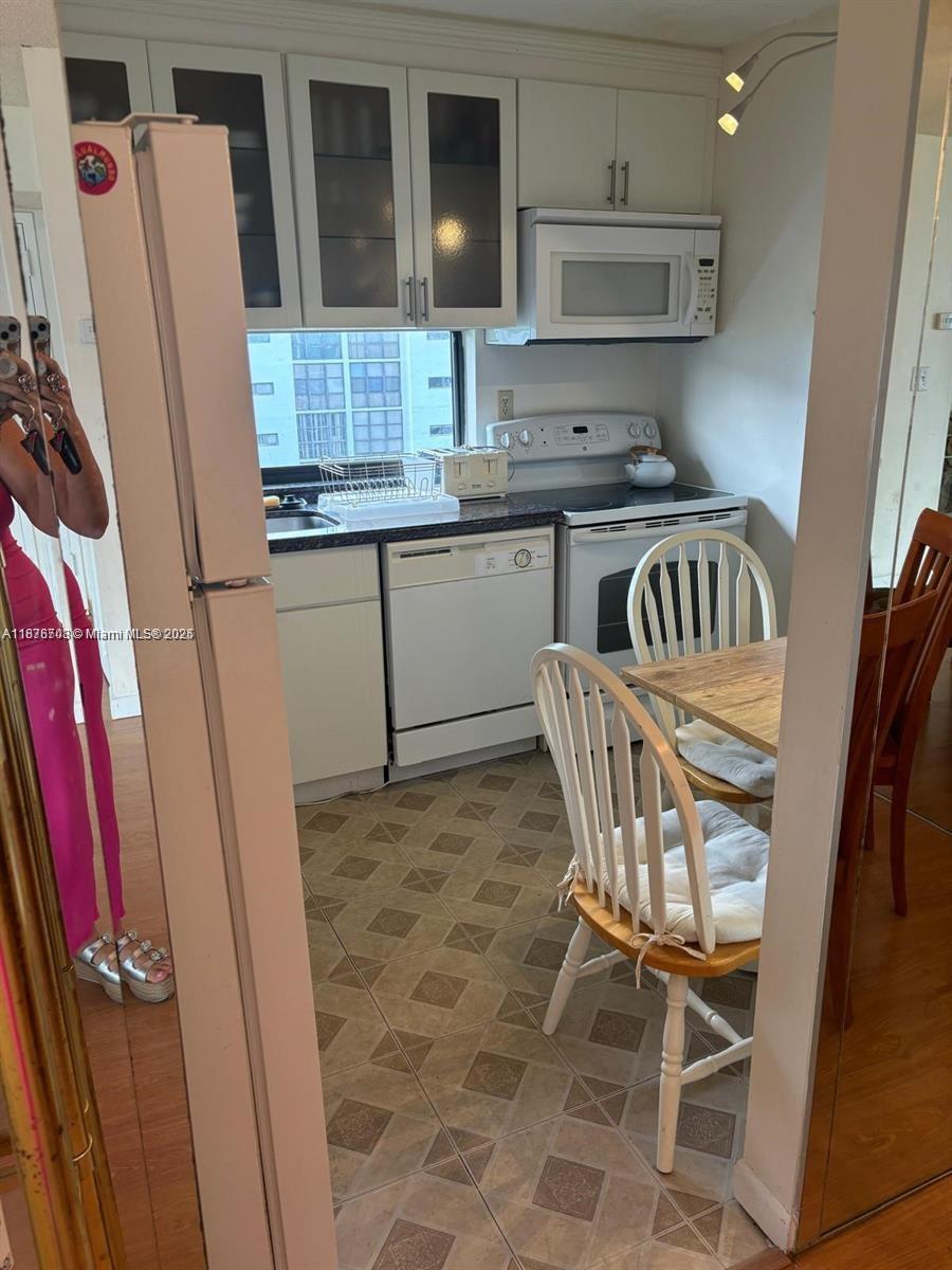17011 North Bay Road, Unit 805 Sunny Isles Beach, FL 33160 - Photo 9 of 25 a kitchen with stainless steel appliances granite countertop a refrigerator a stove a sink and dishwasher
