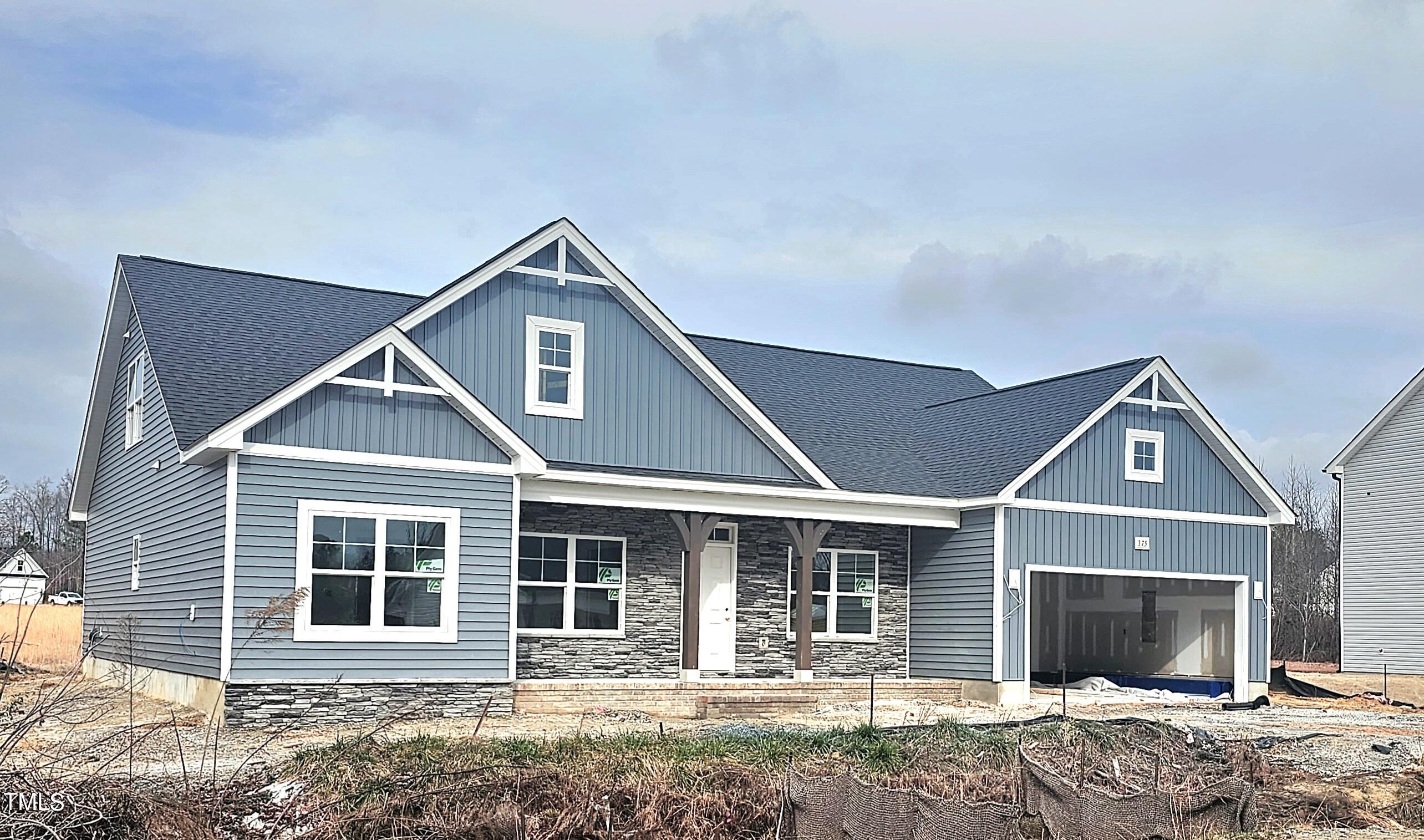 375 Howards Crossing Drive Wendell, NC 27591 - Photo 2 of 16 a front view of a house with a yard and garage