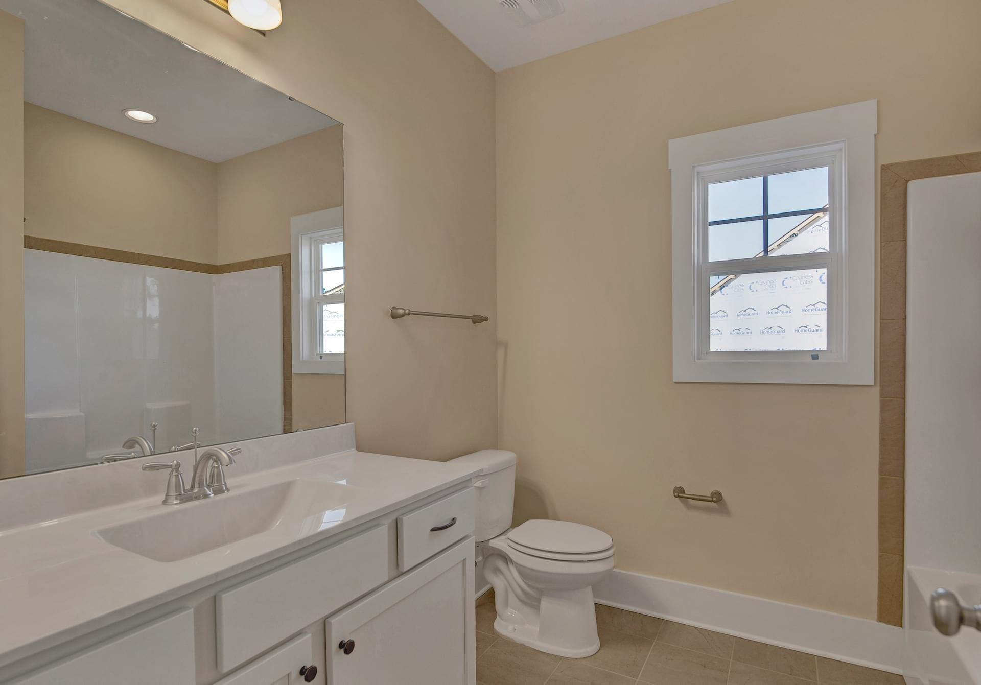 375 Howards Crossing Drive Wendell, NC 27591 - Photo 10 of 16 a bathroom with a toilet a sink and mirror
