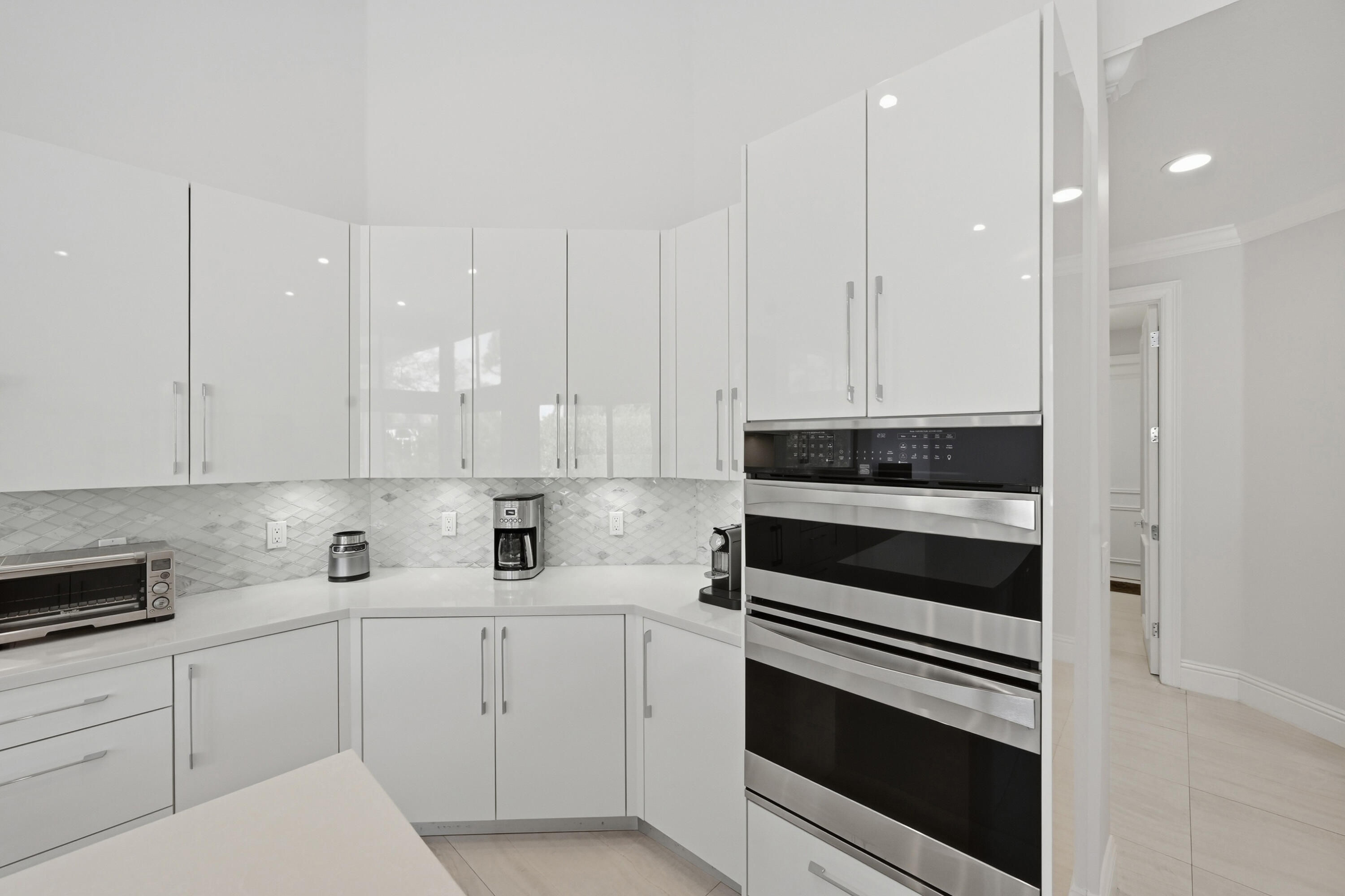 5006 Northwest 24th Circle Boca Raton, FL 33431 - Photo 11 of 52 a kitchen with appliances a sink and cabinets