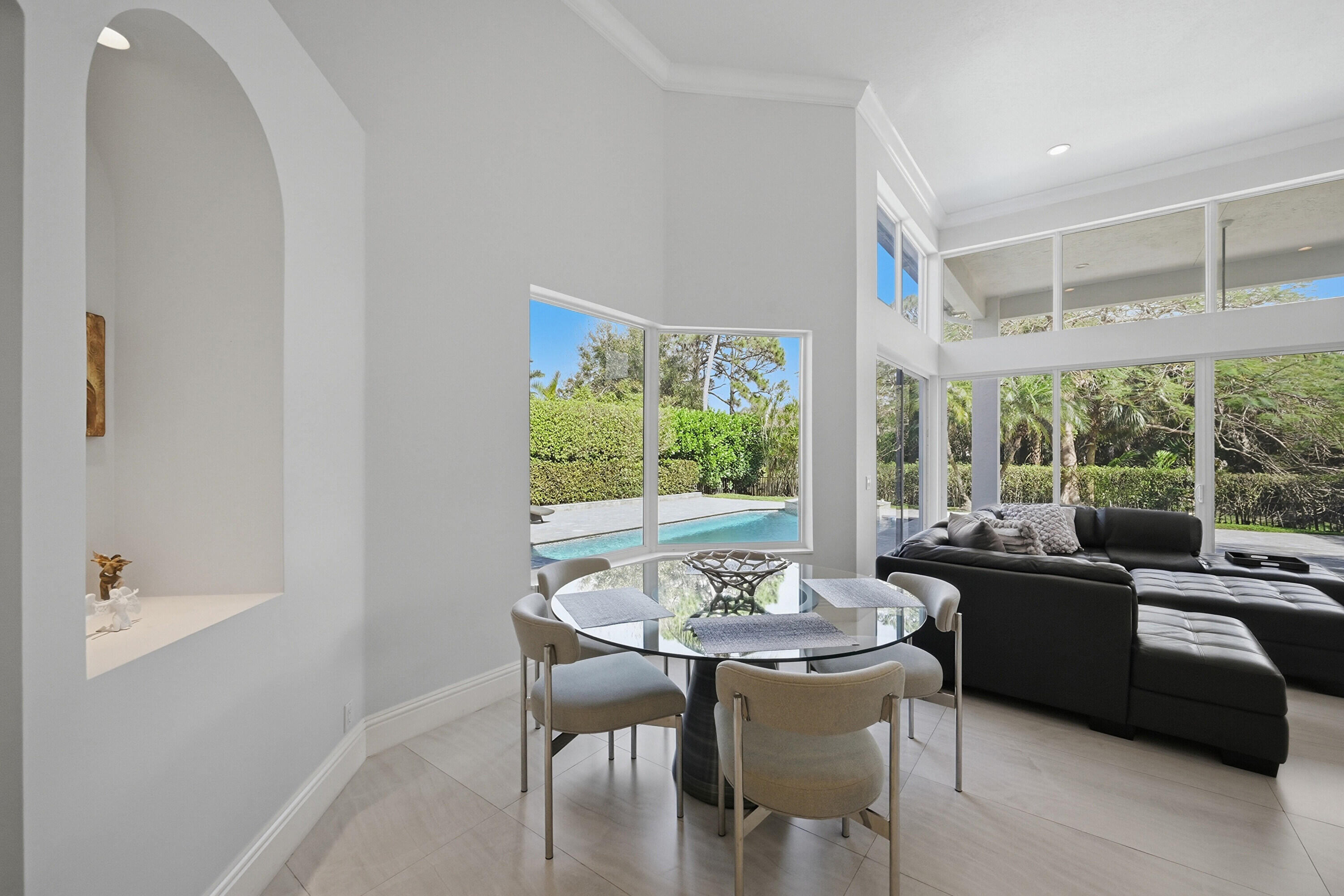 5006 Northwest 24th Circle Boca Raton, FL 33431 - Photo 14 of 52 a dining room with furniture a chandelier and wooden floor