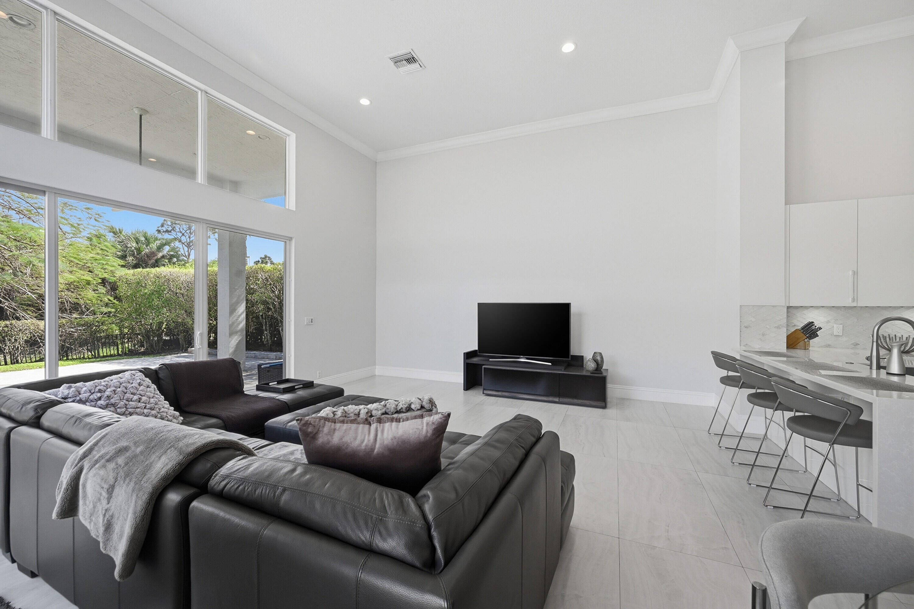 5006 Northwest 24th Circle Boca Raton, FL 33431 - Photo 15 of 52 a living room with furniture and a flat screen tv