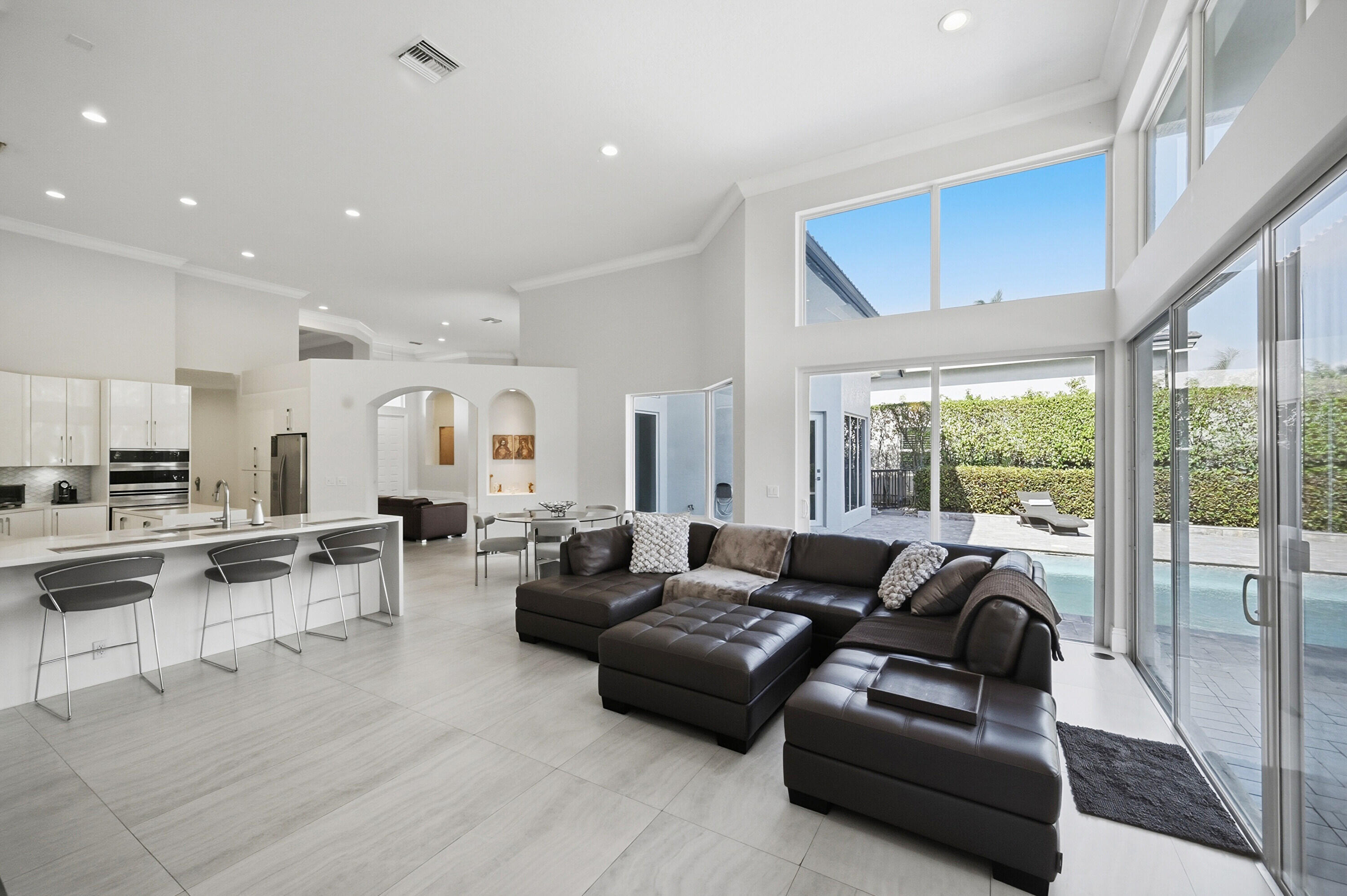 5006 Northwest 24th Circle Boca Raton, FL 33431 - Photo 17 of 52 a living room with furniture wooden floor and a large window